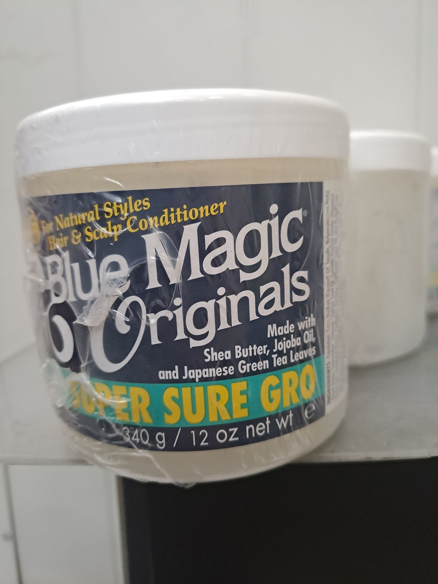 Blue Magic Originals super sure gro. With shea butter, jojoba oil and Japanese Green Tea Leaves.